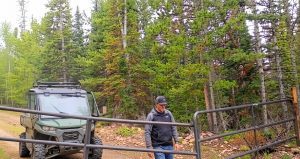 Stealth Cam security photo of UTV and person at ranch gate.